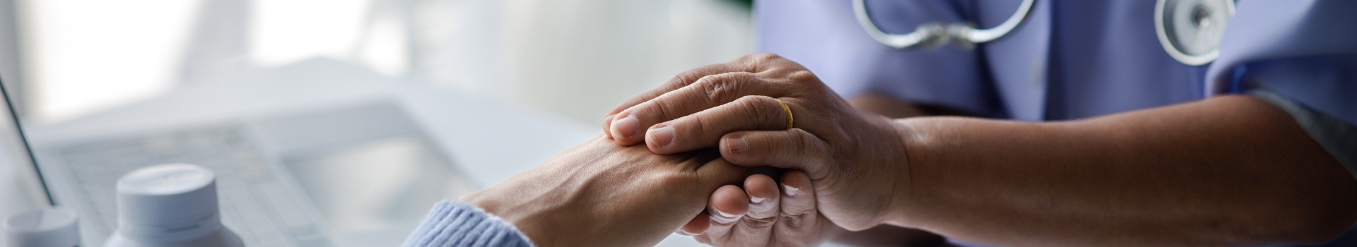 holding hand of patient